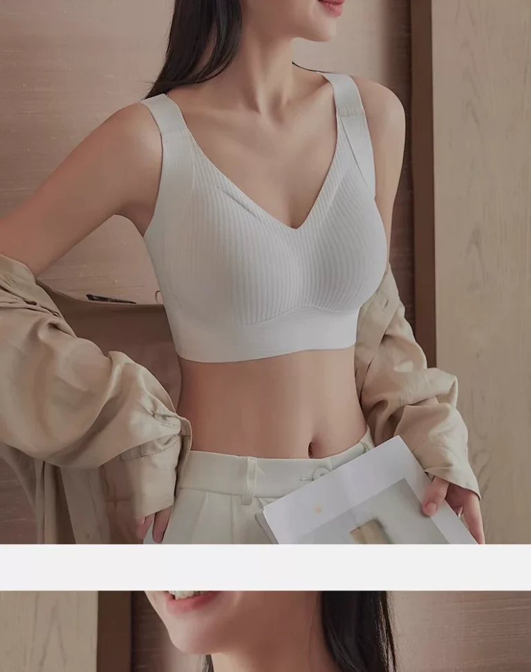 White seamless wide-strap wireless bra styled beneath a light jacket