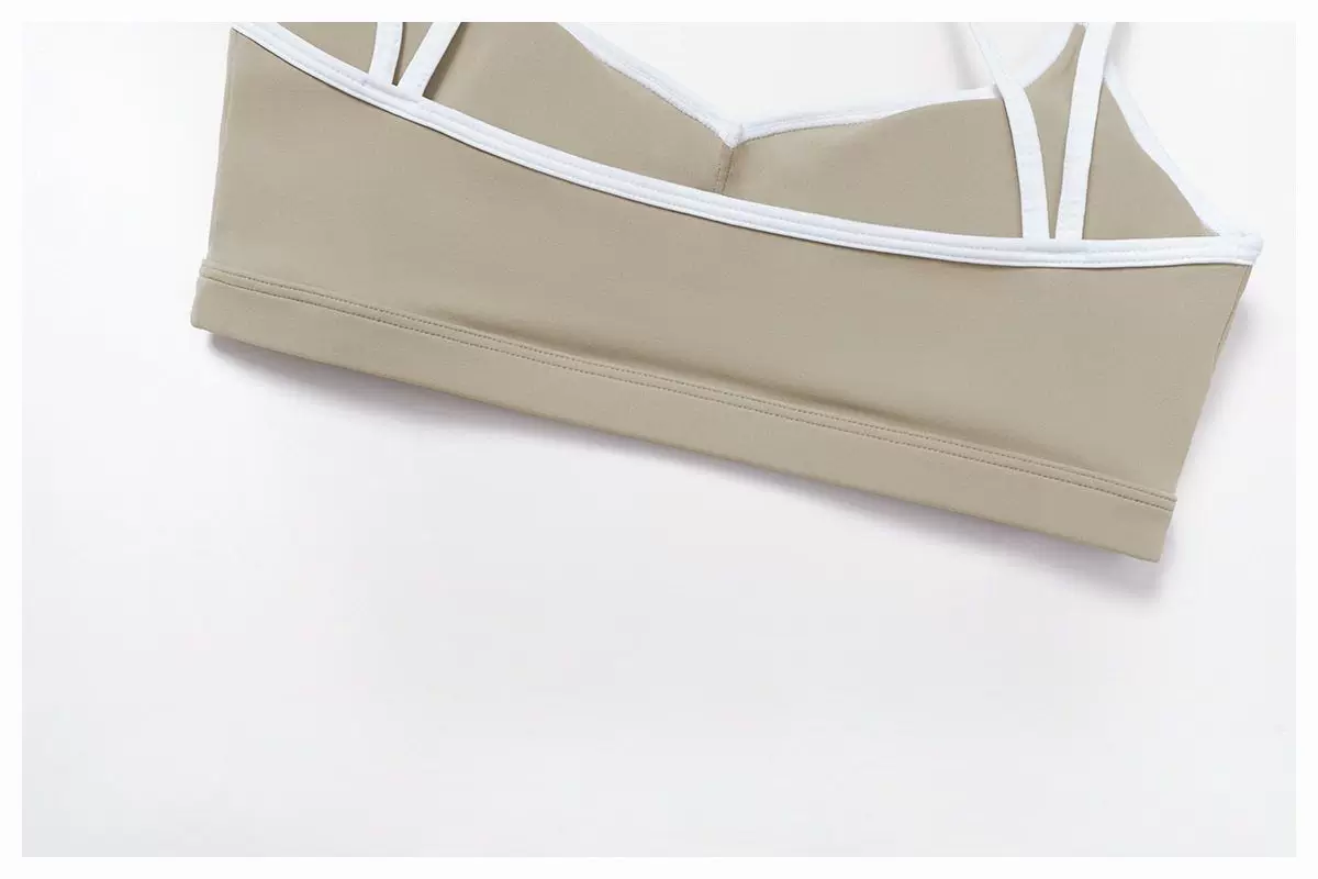 Khaki sports bra lower band and white contrast trim detail