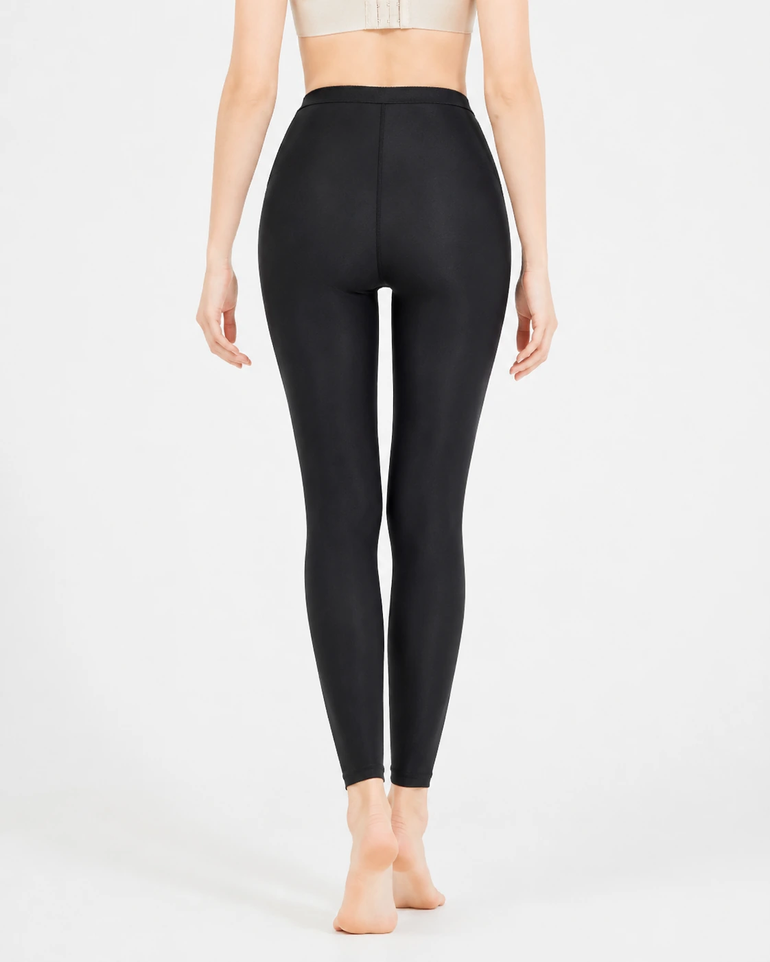 Black high-waist full-length compression leggings back view with shaped rear seams