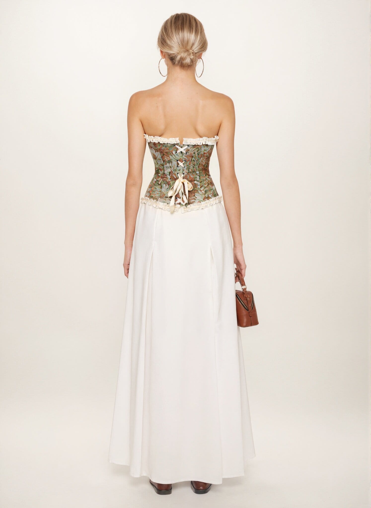 Green floral tapestry corset top styled with a long white skirt