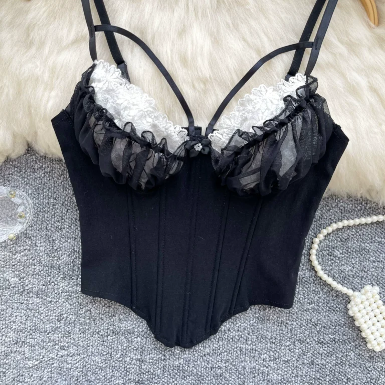 Black corset cami front view with white lace cups, ruffle trim, double straps and soft vertical structure