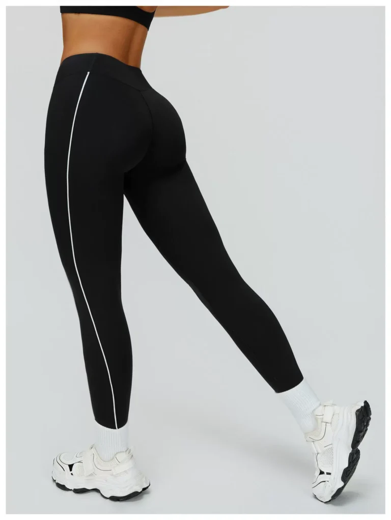 Black high-waist contrast-piping sculpting leggings shown from the back
