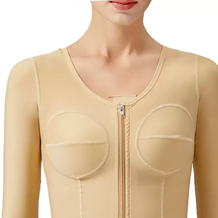 Close-up of beige post-op compression top bust panel seams