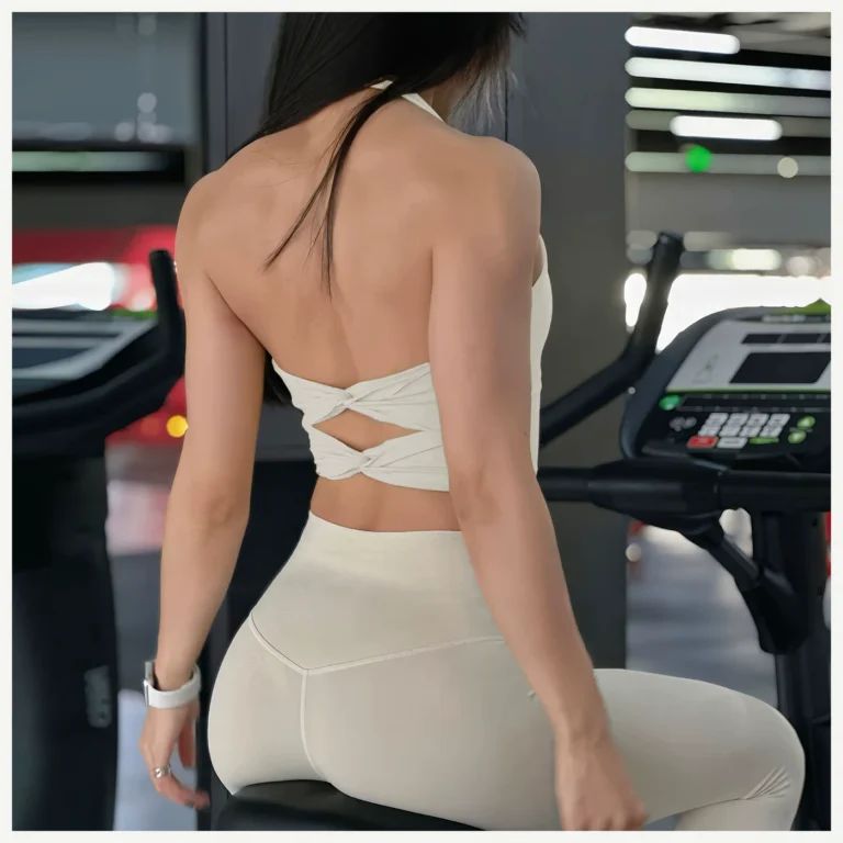 Ivory twist-back sports crop top in a gym setting