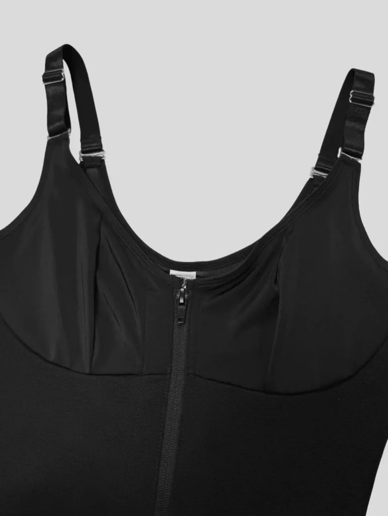 Black shaping bodysuit close-up showing built-in cup seams, adjustable straps and front zipper