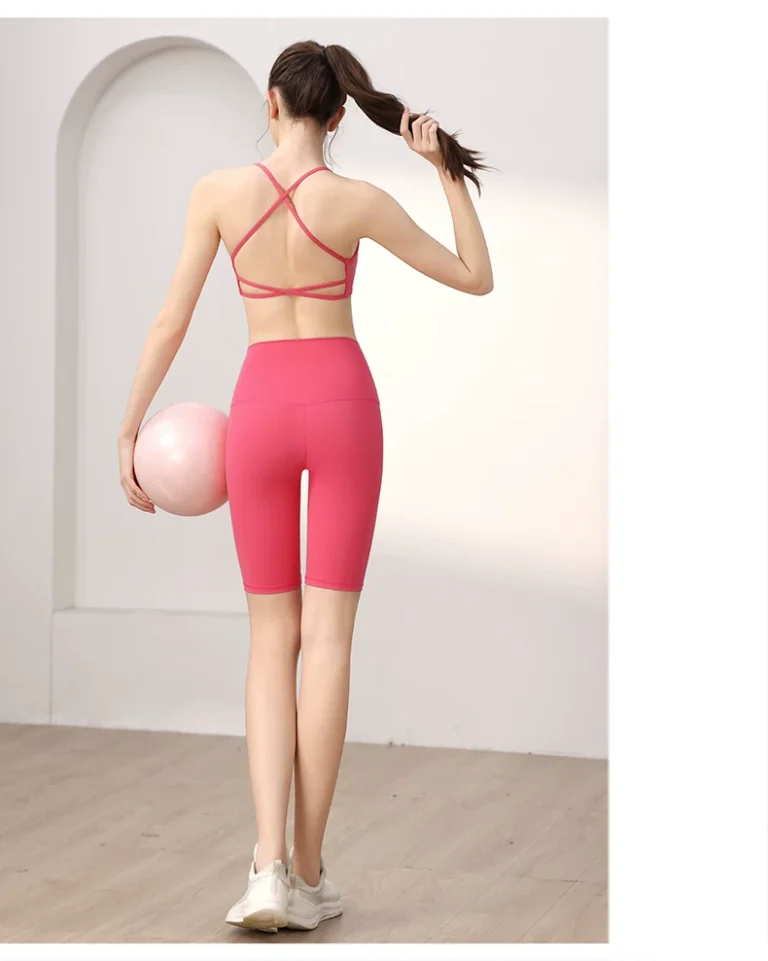 Pink crisscross-back sports bra with high-waist shorts