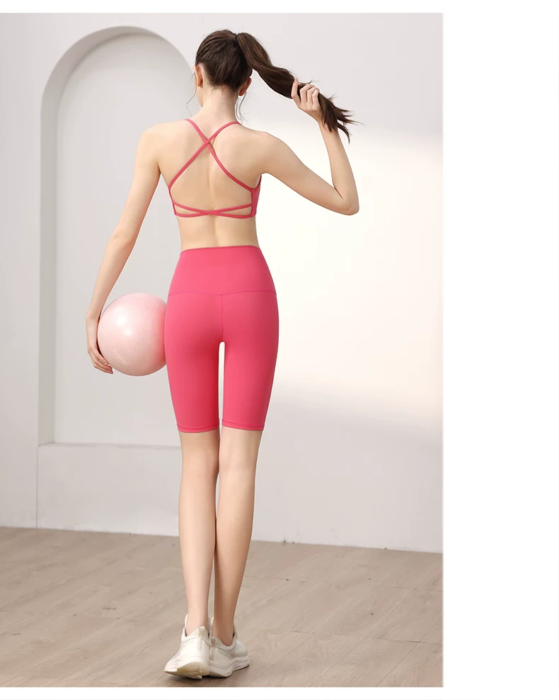 Pink crisscross-back sports bra with high-waist shorts