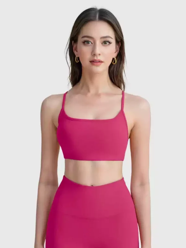Pink scoop-front crisscross sports bra crop top, studio front view
