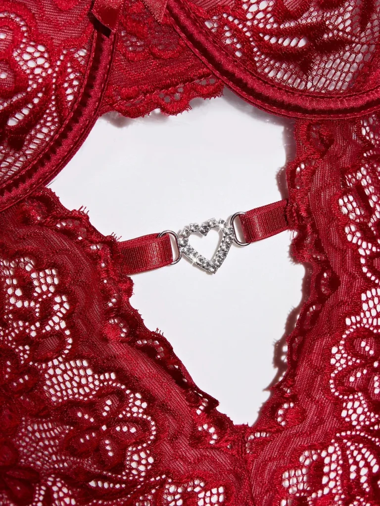 Decorative heart-shaped center-front hardware and open lace panel detail