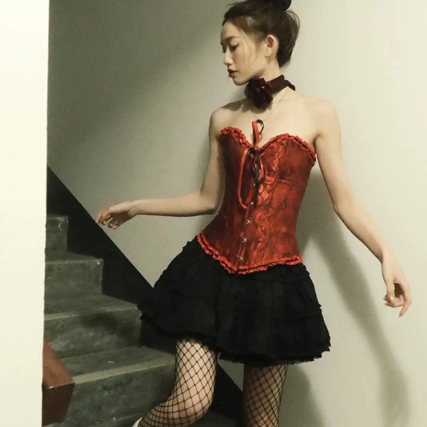 Dark red strapless corset styled with a black layered skirt