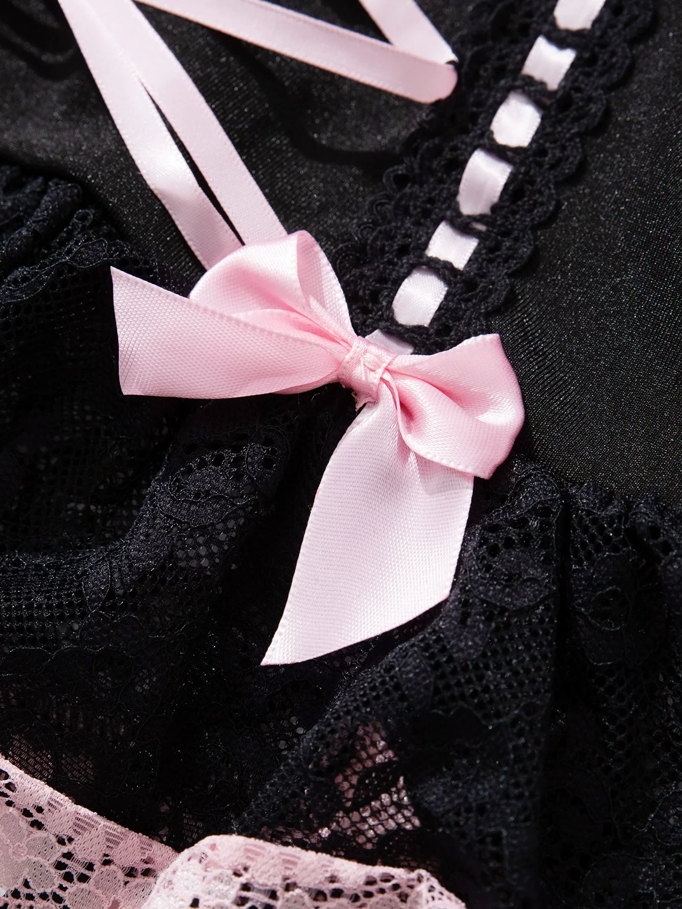 Qinelle black lace and pink bow close-up detail