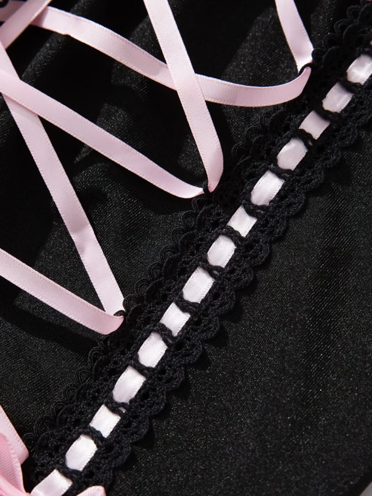 Qinelle black lace corset lacing panel close-up with pink ribbon