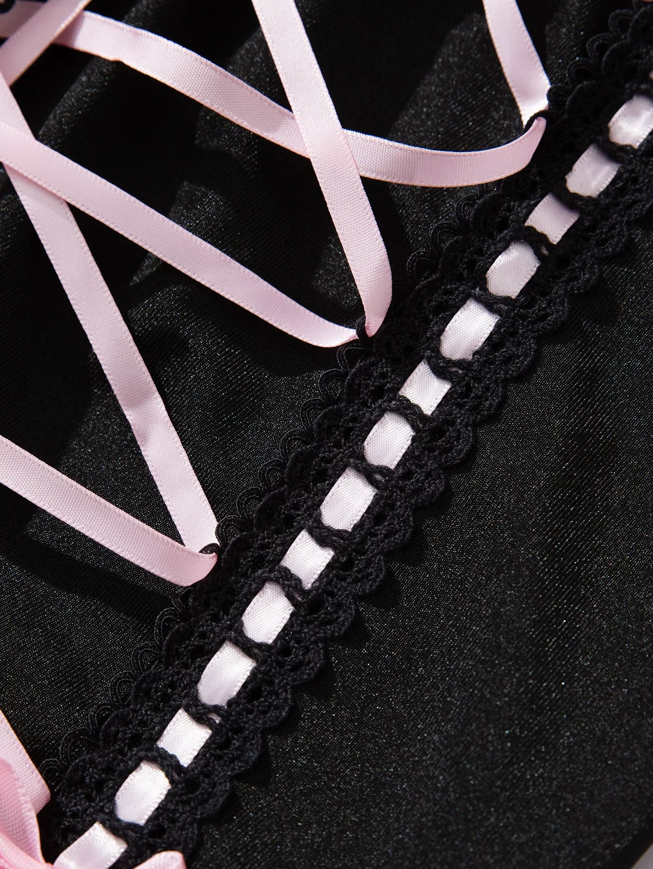 Qinelle black lace corset lacing panel close-up with pink ribbon