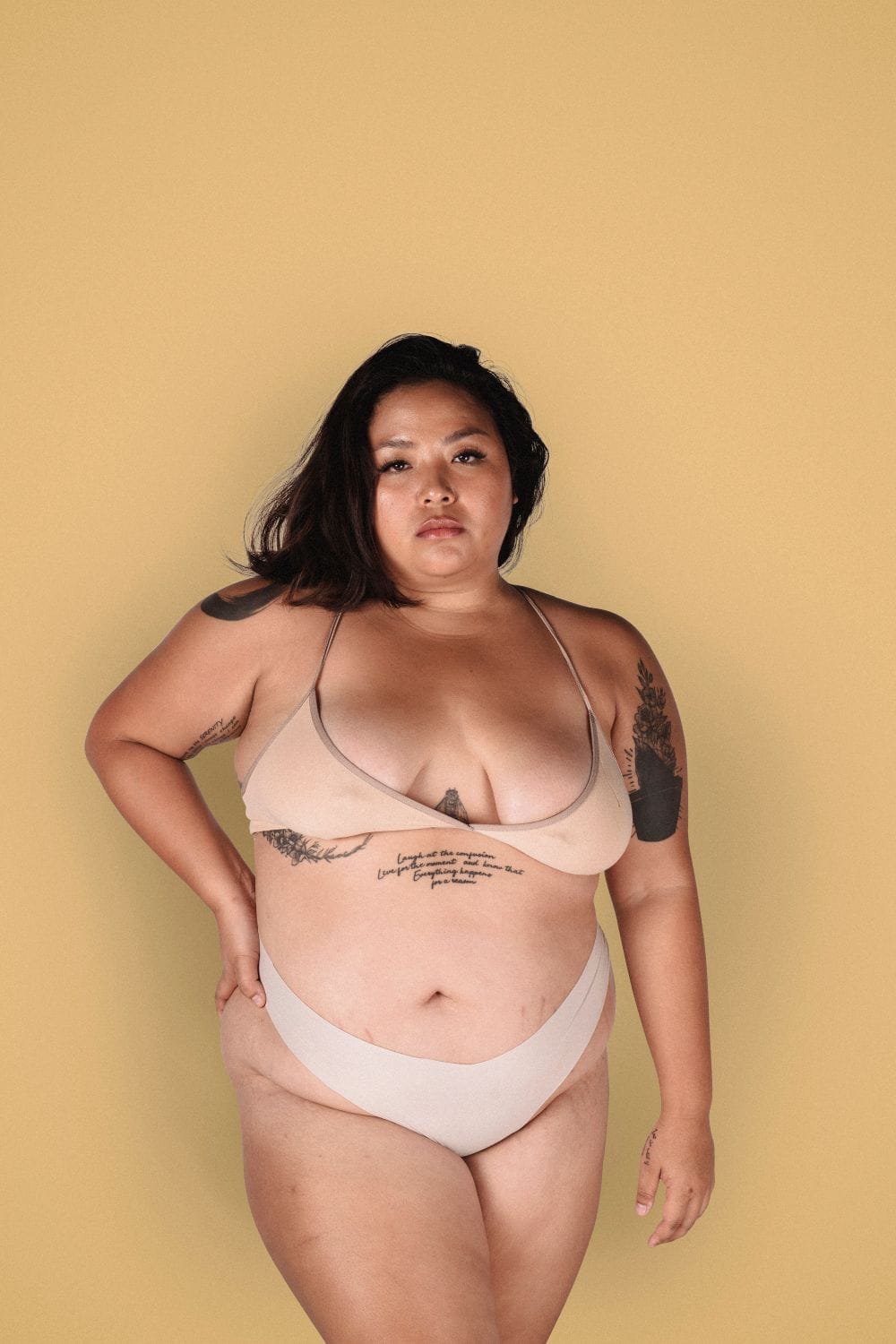 Plus-size woman in neutral underwear for a lower-abdomen shapewear fit guide