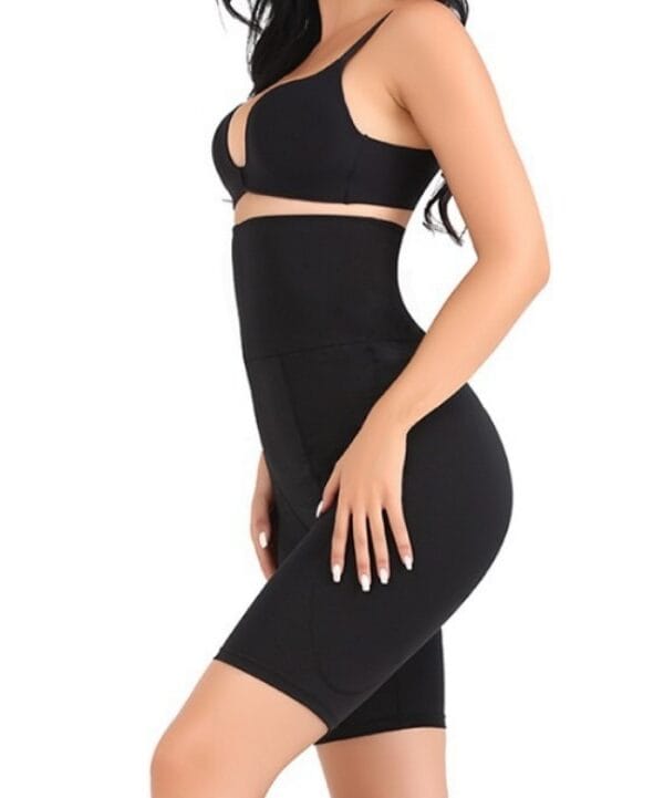 Black high-waist padded hip shapewear shorts on model with fuller side curve